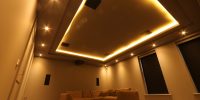 Cinema room with concealed ceiling lighting and beige sofa
